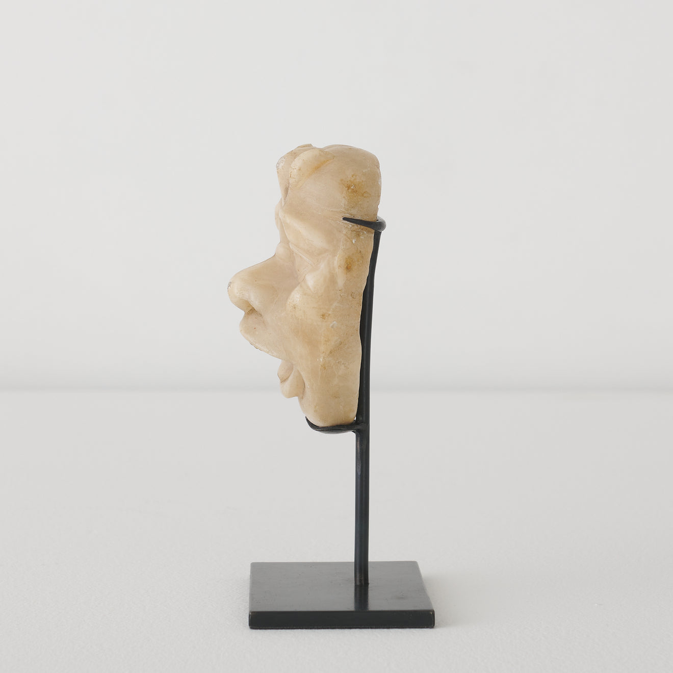 ALABASTER GROTESQUE HEAD STAND